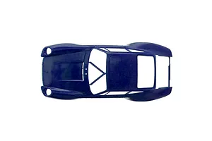 Top-down studio view of an unpainted dark blue plastic model car body shell against a white background.