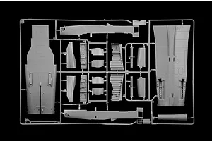 A grey plastic model kit sprue containing aircraft parts like fuselage and wing sections against a black background.