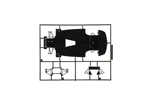 Black plastic model kit sprue containing a chassis pan and suspension parts on a white background.