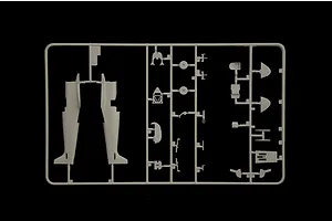 Grey plastic model kit sprue containing aircraft fuselage halves and interior parts against a black background.