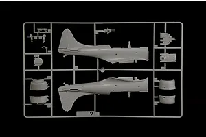 Grey plastic model kit sprue containing aircraft fuselage halves and small interior parts for the SBD-3 Dauntless bomber.