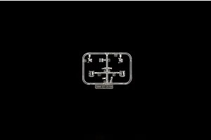 Clear plastic model kit sprue containing canopy parts and cockpit components on a black background.