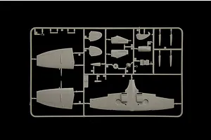 Grey plastic model kit sprue containing unassembled aircraft wings, tail sections, and cockpit parts against a black background.