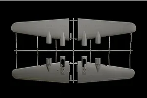 A grey plastic model airplane wing components still attached to their assembly sprue against a black background.