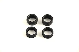 Four black rubber model car tires arranged in a square on a plain white background.