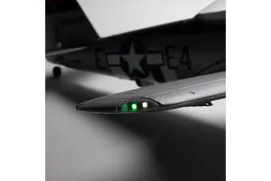 Close-up of the wingtip and navigation lights illuminated on the E-Flite Micro P-47 Thunderbolt RC airplane against a neutral background.