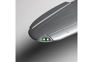 Close-up of an RC plane wing tip featuring integrated navigation lights under a clear cover against a gradient background.