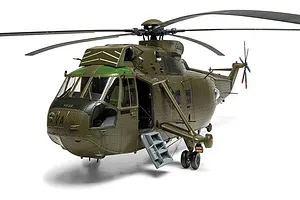 Fully assembled and painted plastic model of a green military helicopter with landing gear and open side door.