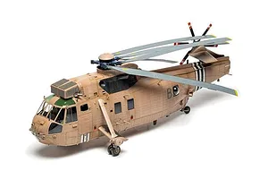 A completed and painted 1/48 scale model of a Westland Sea King HC.4 military helicopter in desert camouflage.