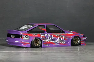 Purple RC drift car body featuring Tec-Arts decals, custom sponsor stickers, and gold mesh wheels viewed from the side and rear.