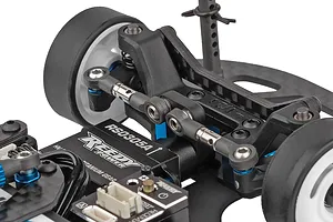 Close-up studio shot of the front suspension, steering servo, and carbon fiber chassis deck on a 1/28 scale RC car kit.