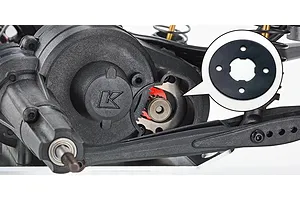 Close-up of the RC car transmission housing with an inset callout showing a gasket or spacer component.