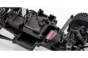Close-up of the chassis interior of the Kyosho Outlaw Renegade 2RSA RC short course truck showing electronics and motor.