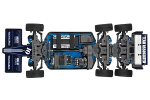 Top down view of the Team Associated RC10 6x6 RC car chassis showing its dual rear axle layout, blue chassis plate, and electronic components.