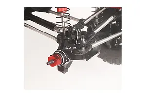 Close-up of Yeah Racing black aluminium front steering hub carrier installed on an RC crawler suspension against a plain background.