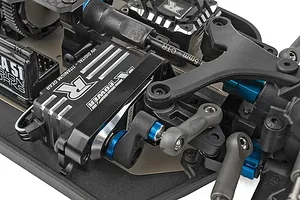 Close-up studio view of the steering servo, linkage, and chassis components inside the Team Associated RC buggy.