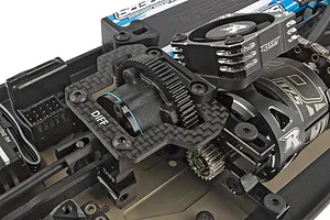 Close-up of the center differential, carbon fiber top plate, and Reedy cooling fan installed on a 1/10 scale RC buggy chassis.
