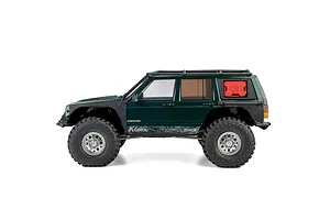 Studio profile view of the Axial SCX10 III Jeep Cherokee XJ RC rock crawler in green with roof rack and red jerry can.