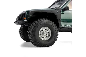 Close-up of front wheel and green body of Axial SCX10 III Jeep Cherokee XJ RC crawler.