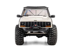 Front view of the white Axial SCX10 III Jeep Cherokee XJ RC rock crawler showing its grille, winch, and tires against a white background.
