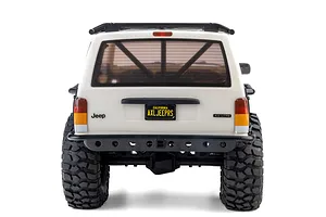 Rear view of the white Axial SCX10 III Jeep Cherokee XJ RC rock crawler showing scale detail, license plate, and off-road tyres.