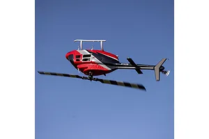 Blade Jet Ranger RC helicopter in flight against a clear blue sky background