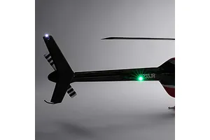 Close-up studio view of the tail section of the Blade Jet Ranger 235CP RC helicopter, highlighting the illuminated tail light and markings.
