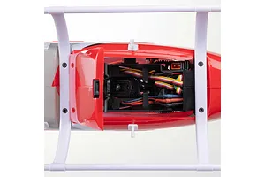 Top-down view of the internal chassis and wiring inside the red and white fuselage of the Blade Jet Ranger RC helicopter.