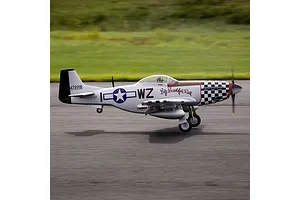 E-Flite P-51D Mustang Big Beautiful Doll RC fighter plane taxiing on an asphalt runway with green grass background.