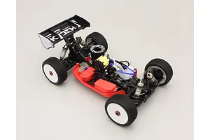 Kyosho nitro RC buggy chassis shown from an elevated rear angle, featuring a red battery and receiver box set installed.