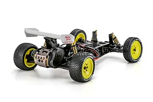 Rear-three-quarter view of the Kyosho Ultima Pro 1/10 electric 2WD RC buggy kit chassis featuring yellow wheels and Option House wing branding.