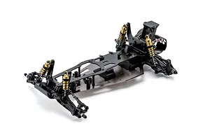 Studio shot of the Kyosho Ultima Pro 1/10 scale 2WD RC buggy unpainted chassis kit showing suspension and shocks.