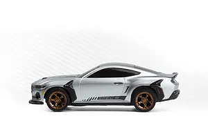 Side view of the silver HPI Nano-TTR Ford Mustang Spec 5 RC car with bronze wheels against a white background.