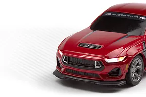 Close-up studio shot of the red HPI Nano-TTR Ford Mustang Spec 5 RC car front end, highlighting illuminated headlights.
