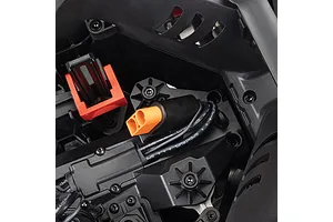 Top-down view of the internal chassis of the ARRMA RC car showing a battery strap mount, wiring, and an orange connector.
