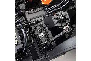 Close-up of the steering servo, linkage, and receiver box setup inside an ARRMA Quake 4S RC monster truck chassis.