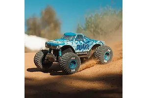 ARRMA Quake 4S blue monster truck kicking up dirt dust on an outdoor dirt track