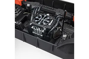 Close-up of the Spektrum Firma ESC installed inside the black composite chassis of the ARRMA Quake 4S RC monster truck.