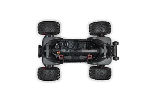 Top-down studio view of the ARRMA 4S RC monster truck chassis showing internal electronics, layout, and off-road tires.