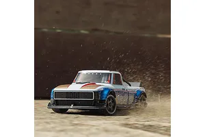 ARRMA Infraction 3S RC truck drifting and kicking up dirt and debris on an outdoor surface