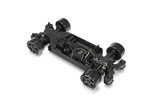 High-angle studio shot of the black chassis and electronics of an ARRMA RC car against a white background.