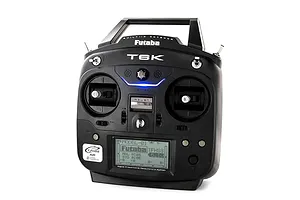 Front studio view of the black Futaba T6K radio transmitter featuring dual gimbals, switches, and a digital LCD screen.