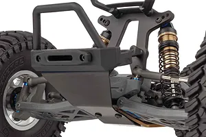 Close-up of the front suspension, chassis, bumper, and shock absorbers of an Element RC Gaterunner 1/10 scale trophy truck.