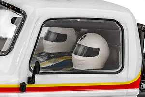 Close-up of the driver and co-driver helmets visible through the side window of the Element RC Gaterunner RC truck body.