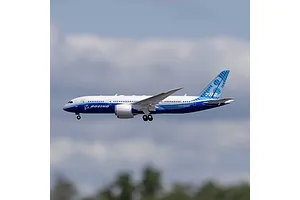 E-Flite Micro Boeing 787 Dreamliner RC airplane in flight against a blue sky background.