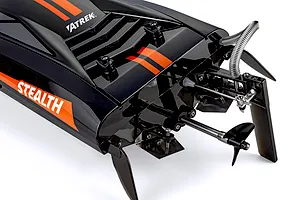 Close-up studio view of the Atrek Stealth RC boat stern, showing the metal propeller, rudder, and black hull with orange stripes.