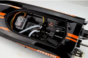 Interior hull view of the Atrek Stealth 25 brushless RC speed boat showing electronics, wiring, and water cooling lines.