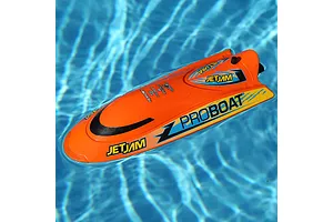 Pro Boat Jet Jam V2 orange RC speed boat floating in a blue swimming pool water.