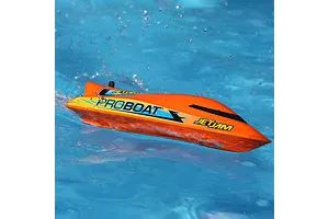 Pro Boat Jet Jam V2 electric RC speed boat in orange running on water with splashes surrounding it.