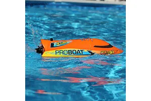Pro Boat Jet Jam V2 orange electric RC speed boat running in water creating splashes.